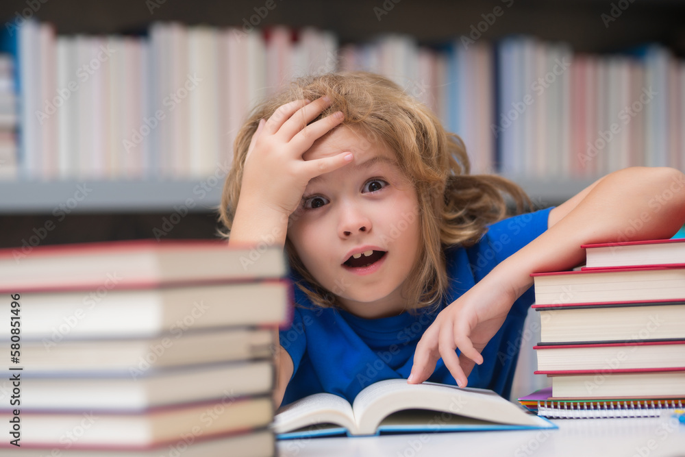 Education Concept. School boy reading book in library. Kids development, learn to read. Pupil reading books in a book store. Education Concept. School boy reading book in library. Kids development, learn to read. Pupil reading books in a book store.