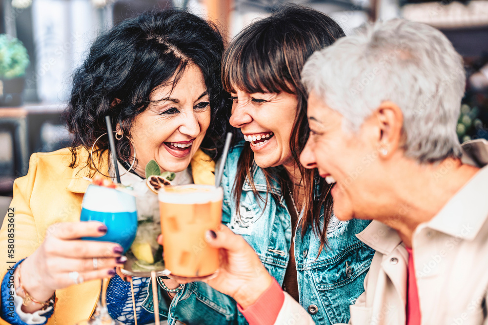 Happy retired friends having fun drinking cocktail at pre dinner party - Senior people women enjoying the happy hour of the weekend together - elderly people lifestyle concept Happy retired friends having fun drinking cocktail at pre dinner party - Senior people women enjoying the happy hour of the weekend together - elderly people lifestyle concept