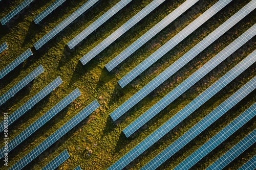 Solar panel rows aerial view. Photovoltaic panels farm from the sky, diagonal rows for renewable solar energy. Reducing  carbon footprint concept, clean green energy for the future.
