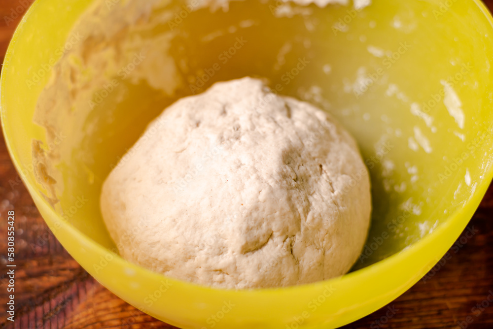 Round dough made of flour, yeast and water in bowl. Cooked dough for baking bread or pizza. Round dough made of flour, yeast and water in bowl. Cooked dough for baking bread or pizza.