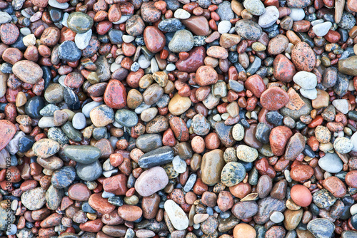 Wet pebbles top view. Beautiful pattern of stones