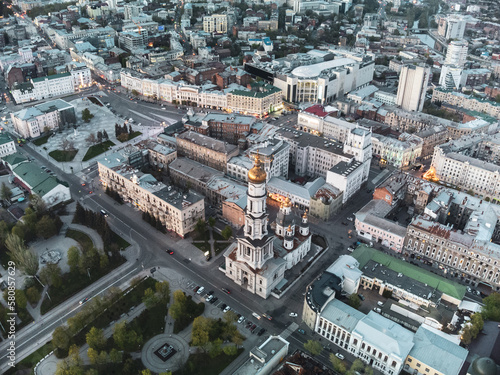 Aerial look down view on Dormition Cathedral near Independence square in evening lights of Kharkiv city downtown, Ukraine.