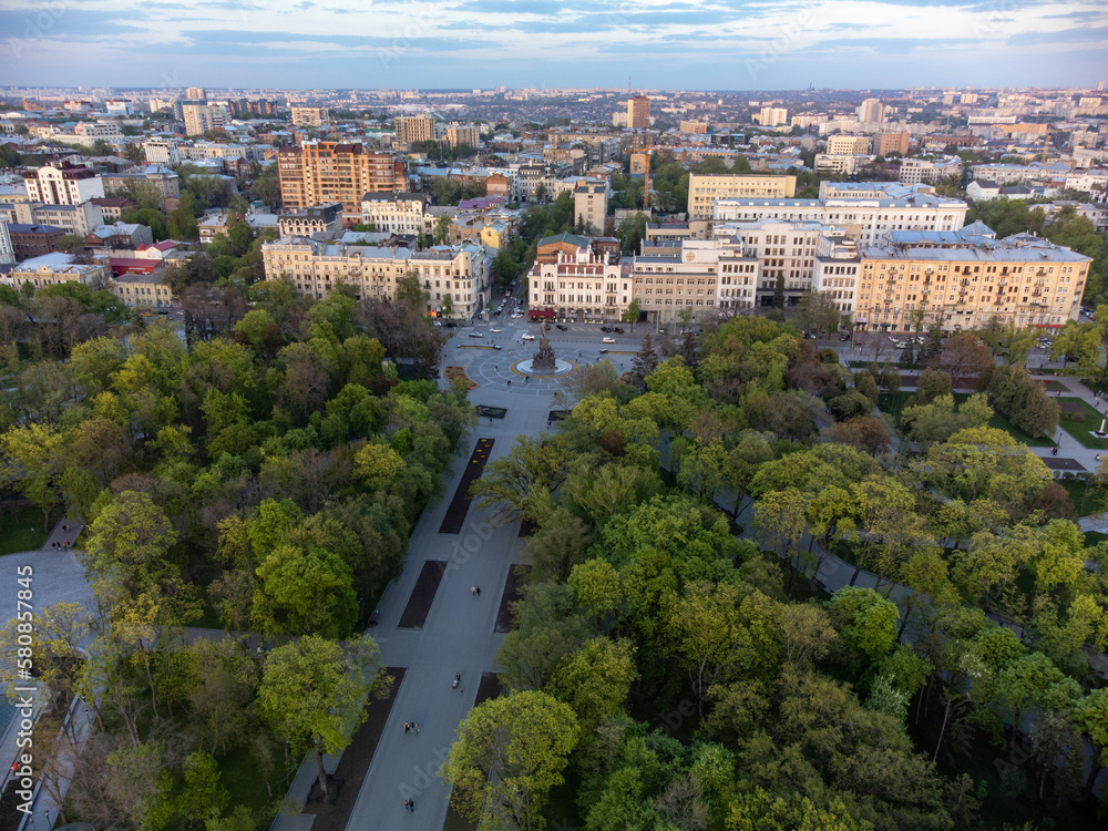 Aerial green spring Shevchenko City Garden with Taras Shevchenko Monument at sunset. Tourist attraction in central city park, Kharkiv, Ukraine