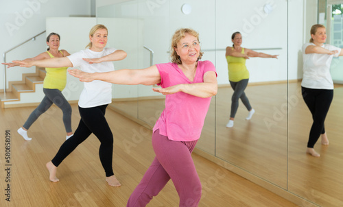 Elderly women having dance training in studio, practicing active dances, healthy lifestyle