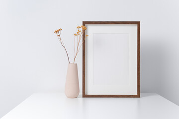 Wooden artwork frame mockup in white room with dry flowers decor