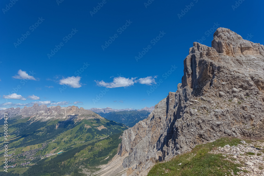 Panoramic view of famous Dolomites mountain peaks. Northern side of Latemar rocky walls and in the background the Catinaccio massif, South Tyrol, Italy. Awesome mountain panorama