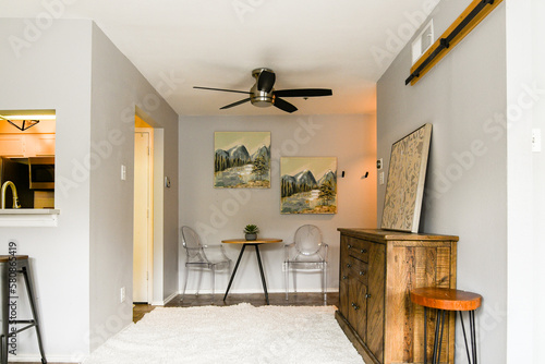 Wood buffet piece in a small living and dining area, natural light, nobody, 
