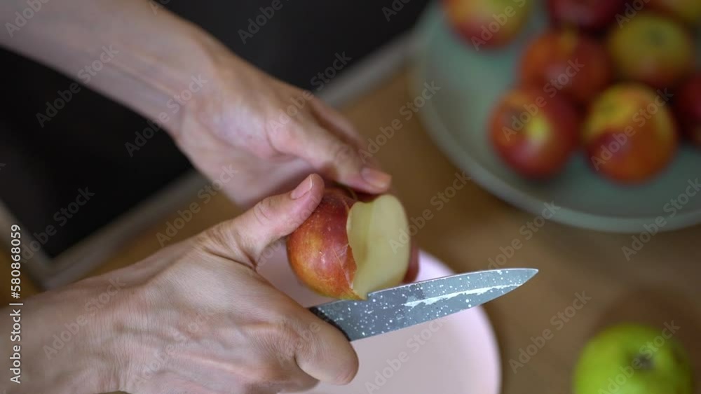 closeup female hands cutting apples with a knife closeup female hands cutting apples with a knife