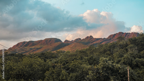 Nature's breathtaking beauty on full display - a majestic mountain range rising up on the horizon, painted in stunning hues of blue and green, beckoning the adventurous at heart to explore and discove photo