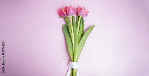 Bouquet of pink tulips flowers on pink background. Card for Mothers day, 8 March, Happy Easter. Waiting for spring. Greeting card or wedding invitation. Flat lay, top view © Oksana Kalinina