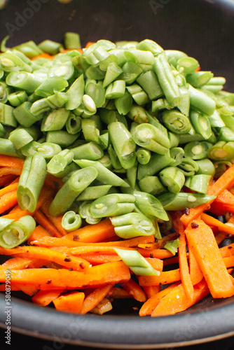 Sizzling Chopped Green Beans and Carrots in Frying Pan