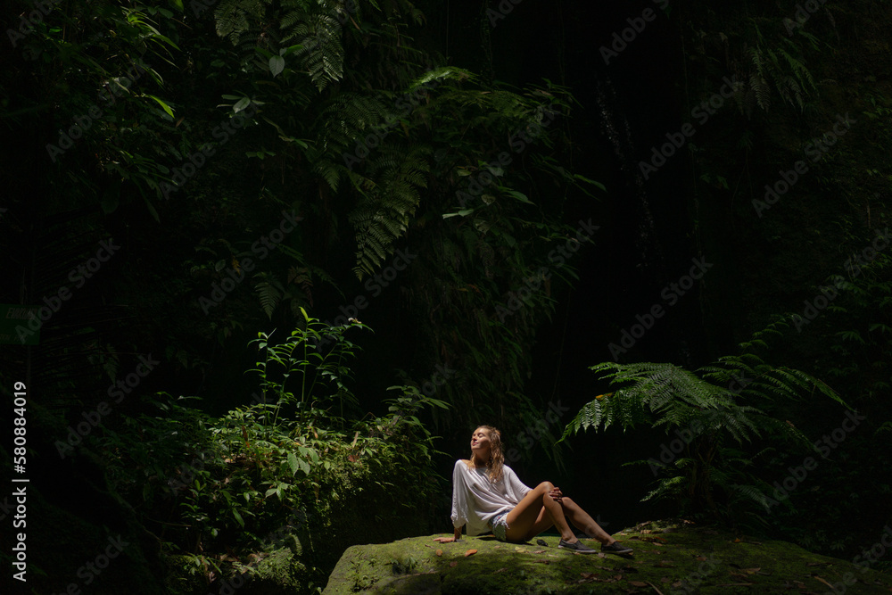 Fototapeta premium Young woman walks in a tropical jungle park, Bali.