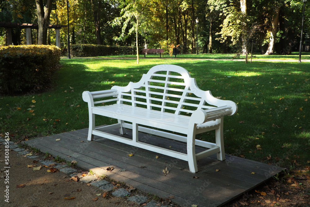 Beautiful white bench in public city park Beautiful white bench in public city park