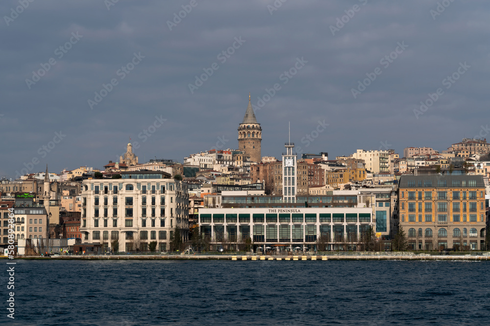 View of the Beyoglu district in Istanbul and the Galata Tower from the waters of the Golden Horn Bay on a sunny day, Istanbul, Turkey