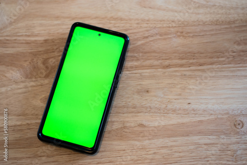 Cell phone in a table with green screen