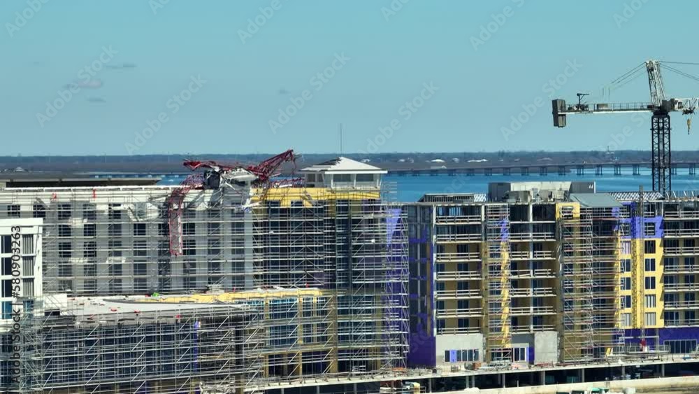 Aerial view of ruined by hurricane Ian construction crane on high apartment building site in Port Charlotte, USA Aerial view of ruined by hurricane Ian construction crane on high apartment building site in Port Charlotte, USA