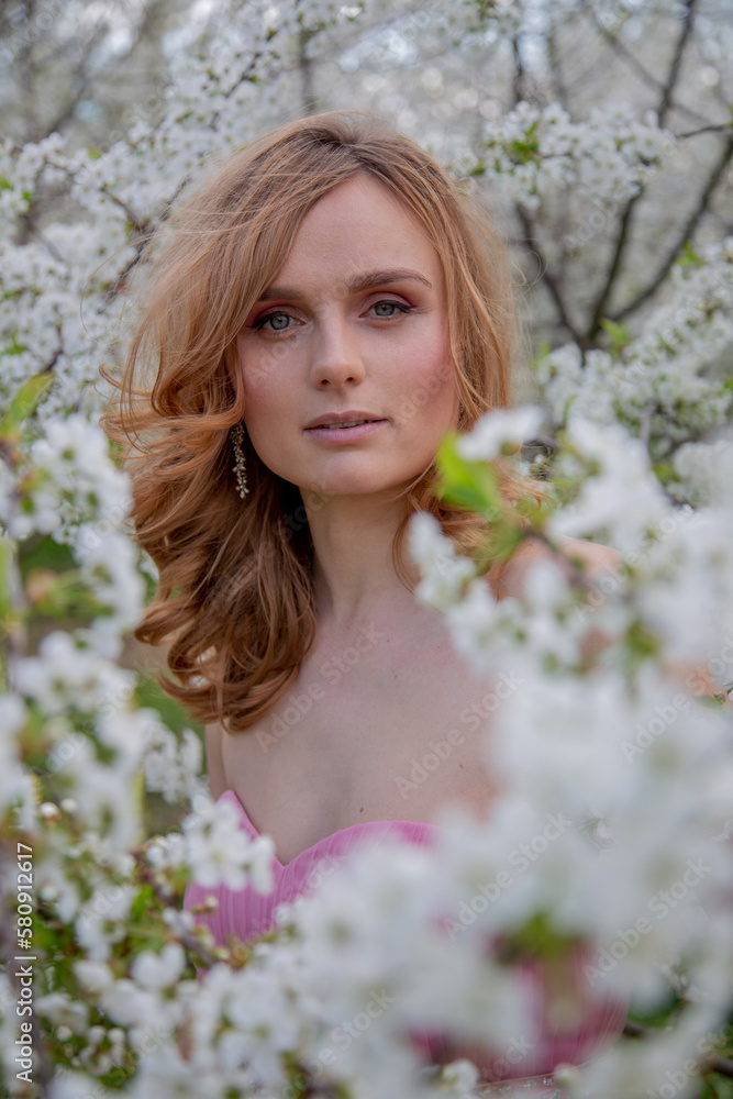 Portrait of a girl in a blooming garden. Blooming trees, traditional asian, travel, seasonal april background. Portrait of a girl in a blooming garden. Blooming trees, traditional asian, travel, seasonal april background.