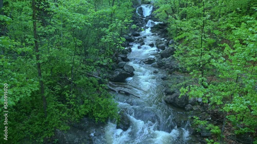 High angle view of flow waterfall creek in green forest High angle view of flow waterfall creek in green forest