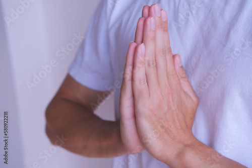 Close up of hands of a man praying on white background. Prayer concept