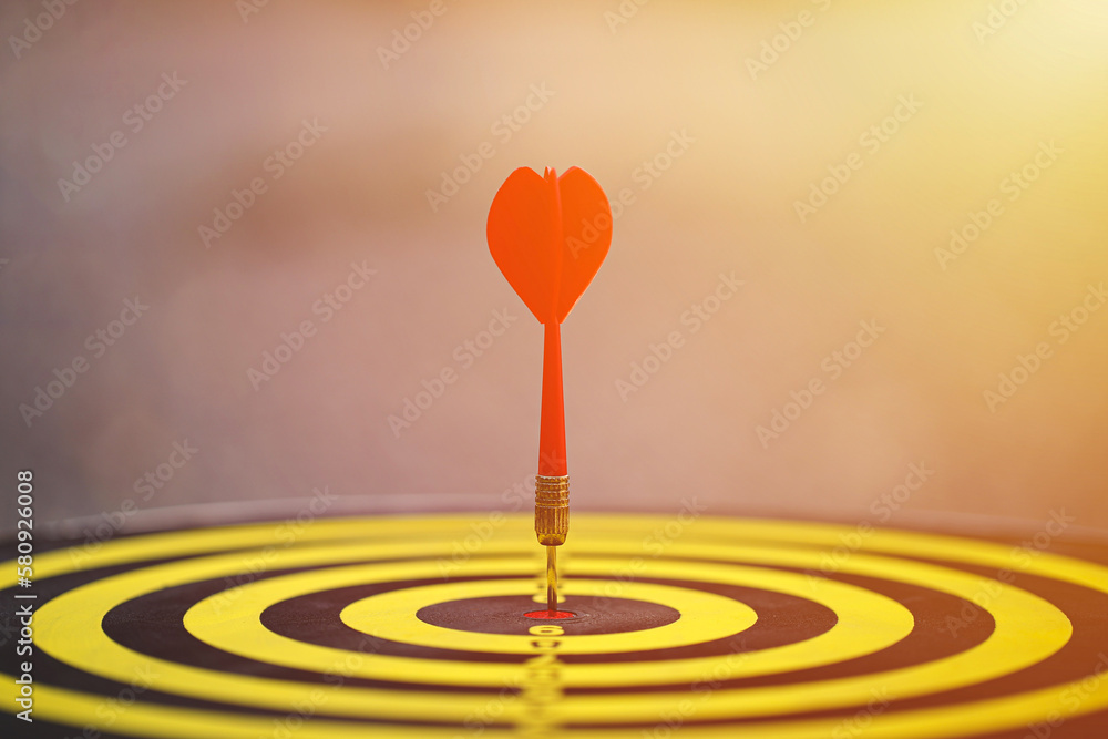 Red dart hit to center of dartboard. Concepts of Business marketing goal, Successful business. Business targeting. Red dart hit to center of dartboard. Concepts of Business marketing goal, Successful business. Business targeting.