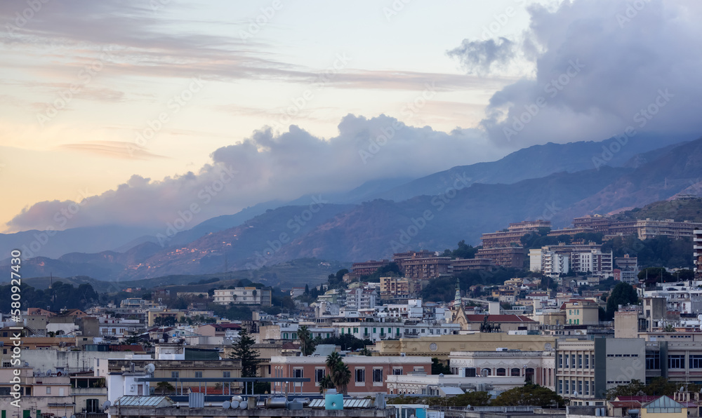 Homes and Apartment Buildings in a touristic city Messina, Sicilia, Italy. Cloudy Sunrise Sky. Aerial Homes and Apartment Buildings in a touristic city Messina, Sicilia, Italy. Cloudy Sunrise Sky. Aerial