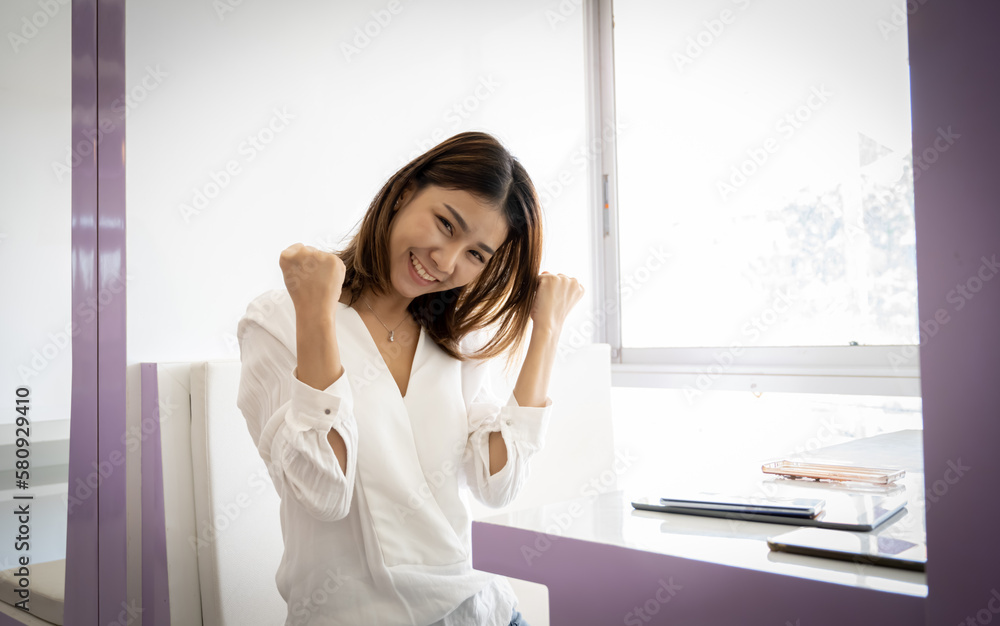 Beautiful asian businesswoman posing with joy in her office. Beautiful asian businesswoman posing with joy in her office.