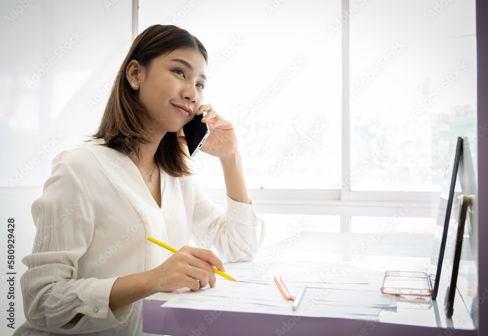 Beautiful asian businesswoman talking to her boss about today's Beautiful asian businesswoman talking to her boss about today's