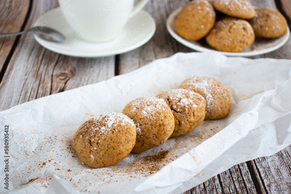 Freshly baked cookies with cinnamon, coffee. Sweet lunch. On a wooden background