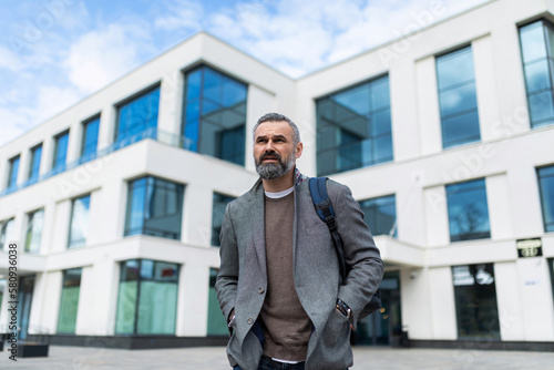 Wallpaper Mural mature adult male financier with gray hair and beard on the background of the building Torontodigital.ca