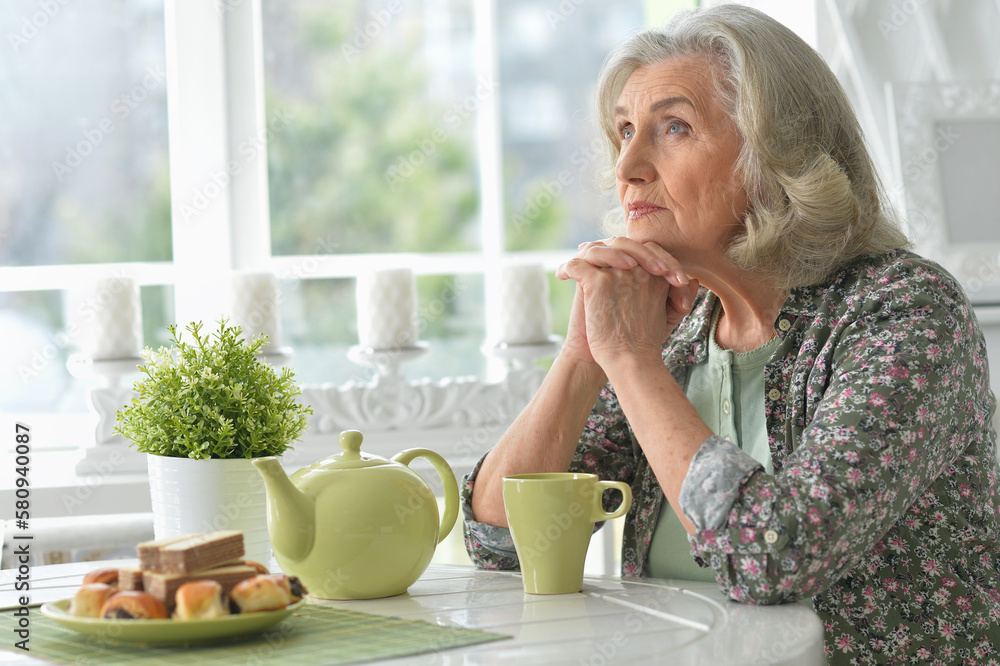 Beautiful sad senior woman drinking tea Beautiful sad senior woman drinking tea