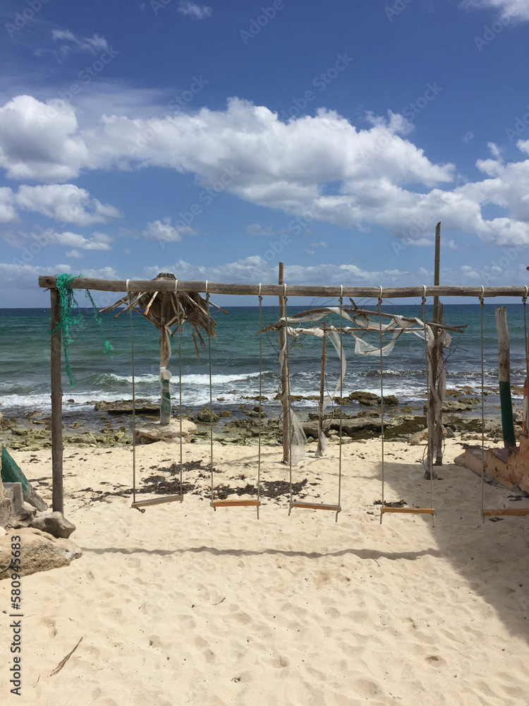 Swings at beach against sky during sunny day Swings at beach against sky during sunny day