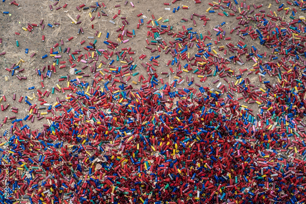 High angle view of colorful shotgun shells on field High angle view of colorful shotgun shells on field