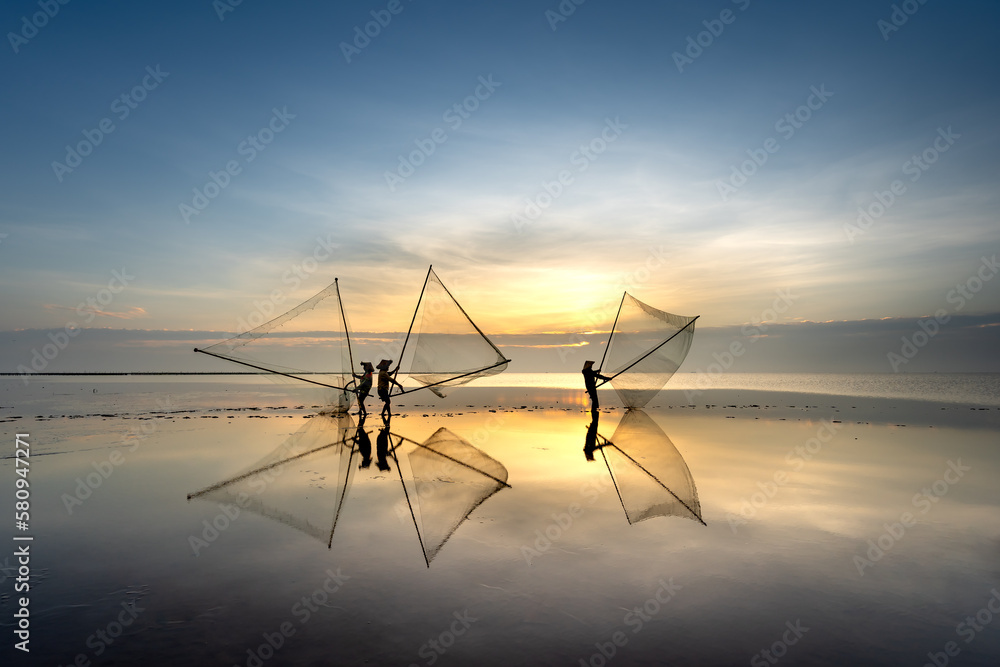 Naklejka premium The image of fishermen in fishing village using homemade tools to catch clam at sea at dawn at Diem Dien beach, Thai Thuy commune, Thai Binh province, Vietnam