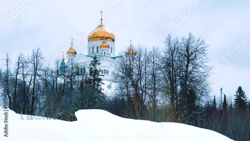 Belogorsky St. Nicholas Orthodox Missionary Monastery. Russia, Perm Krai, Belaya Gora. The temple on the hill in winter. Monastery on the background of snow. 4K photo