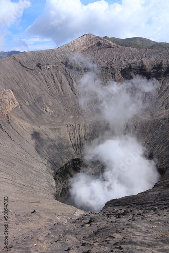 puff of smoke coming out from the open crater of Mount Bromo