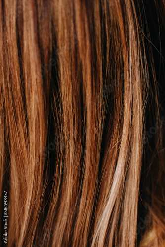 Close up of brunette or brown hair. Female long brown hair. Background with copy space. Selective focus. 