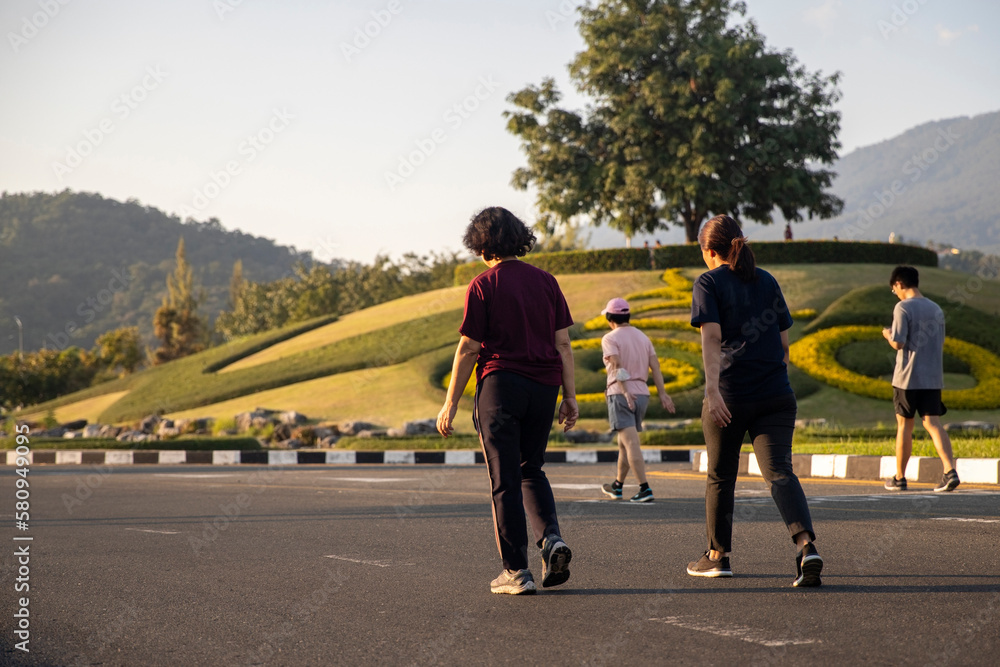 Fototapeta premium Group of people exercise walking in the park on sunlight in morning