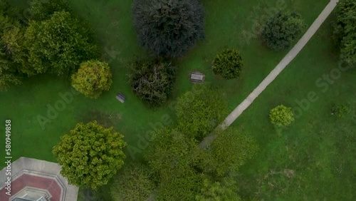 Aerial drone shot panning across Goodale Park in Columbus, Ohio revealing the lush green trees, gazebo and walking paths of the park. photo