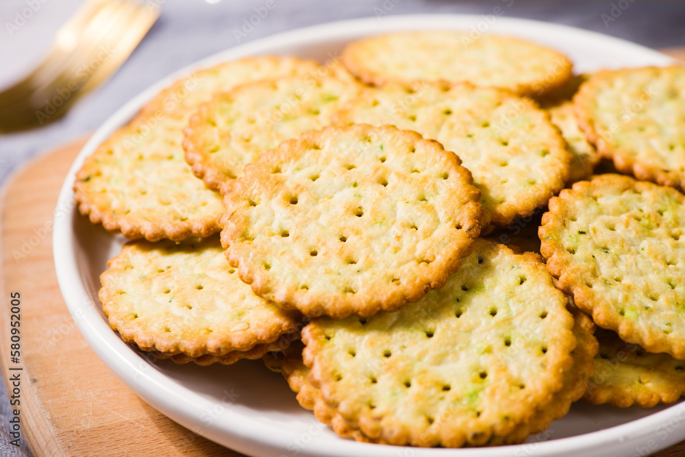 round thin crispy biscuits or crackers on wooden table