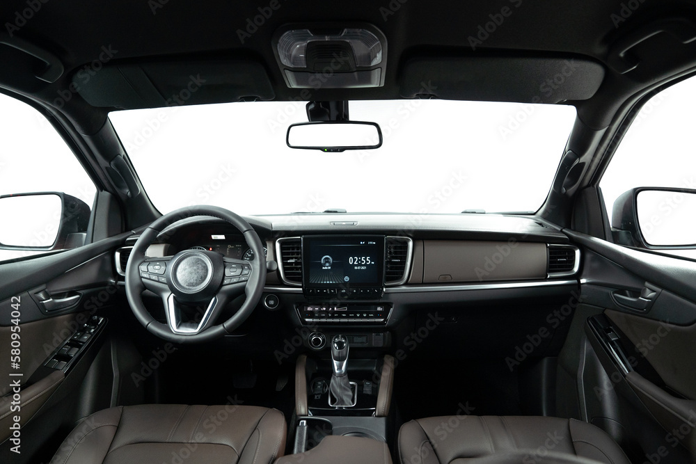 Dark luxury car Interior - steering wheel, shift lever and dashboard. Car inside. Beige comfortable seats, steering wheel, dashboard, climate control, speedometer, display.