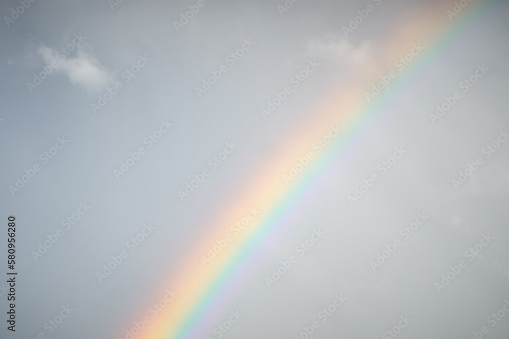 Multicolored rainbow on the background of a clear blue sky Multicolored rainbow on the background of a clear blue sky