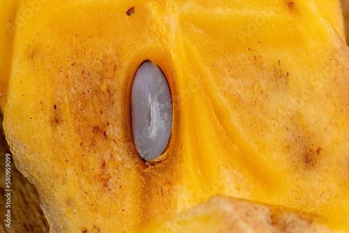 Half-ripe Orange persimmon, close up photo