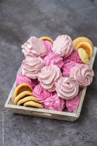 handmade fruit marshmallows and cookies in a wooden tray on the table. home bakery concept.