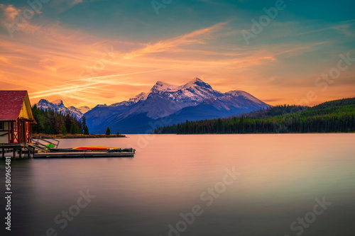 Sunset above boat house and Maligne Lake in Jasper National Park, Canada