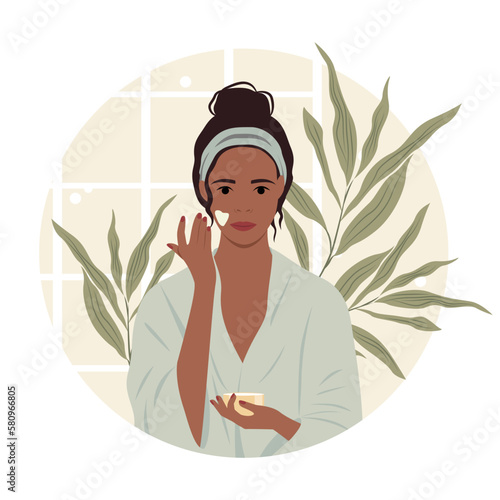 Vector illustration of a dark-skinned girl in a bathrobe applying cream on her face in the bathroom. Banner concept of cosmetology, beauty, home care, cosmetic procedures at home.