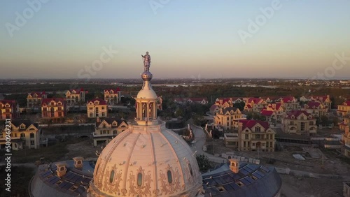 Drone pilot stands on dome of abandoned building near Shanghai, China photo