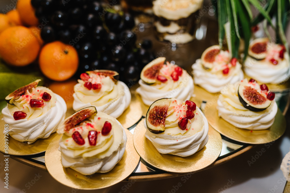 Candy bar. Sweet table for celebration. Cakes with fruit on a festive table in a restaurant. Closeup details. Candy bar. Sweet table for celebration. Cakes with fruit on a festive table in a restaurant. Closeup details.