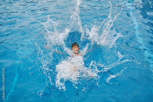 Child jump, swim in the pool, sunbathes, swimming in hot summer day. Relax, Travel, Holidays, Freedom concept.