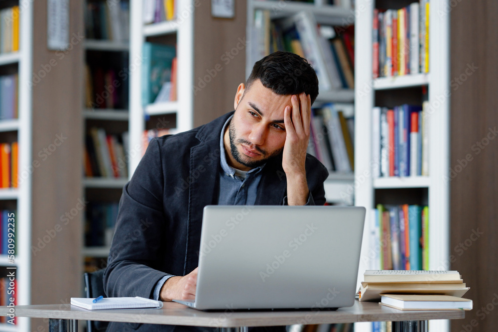 Man suffering migraine massaging head Man suffering migraine massaging head