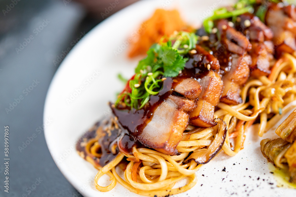 Stewed pork slice with noodles and vegetables in plate